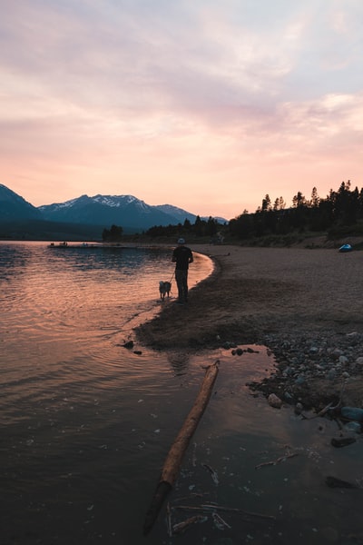 Sunset when two people walking on the beach
